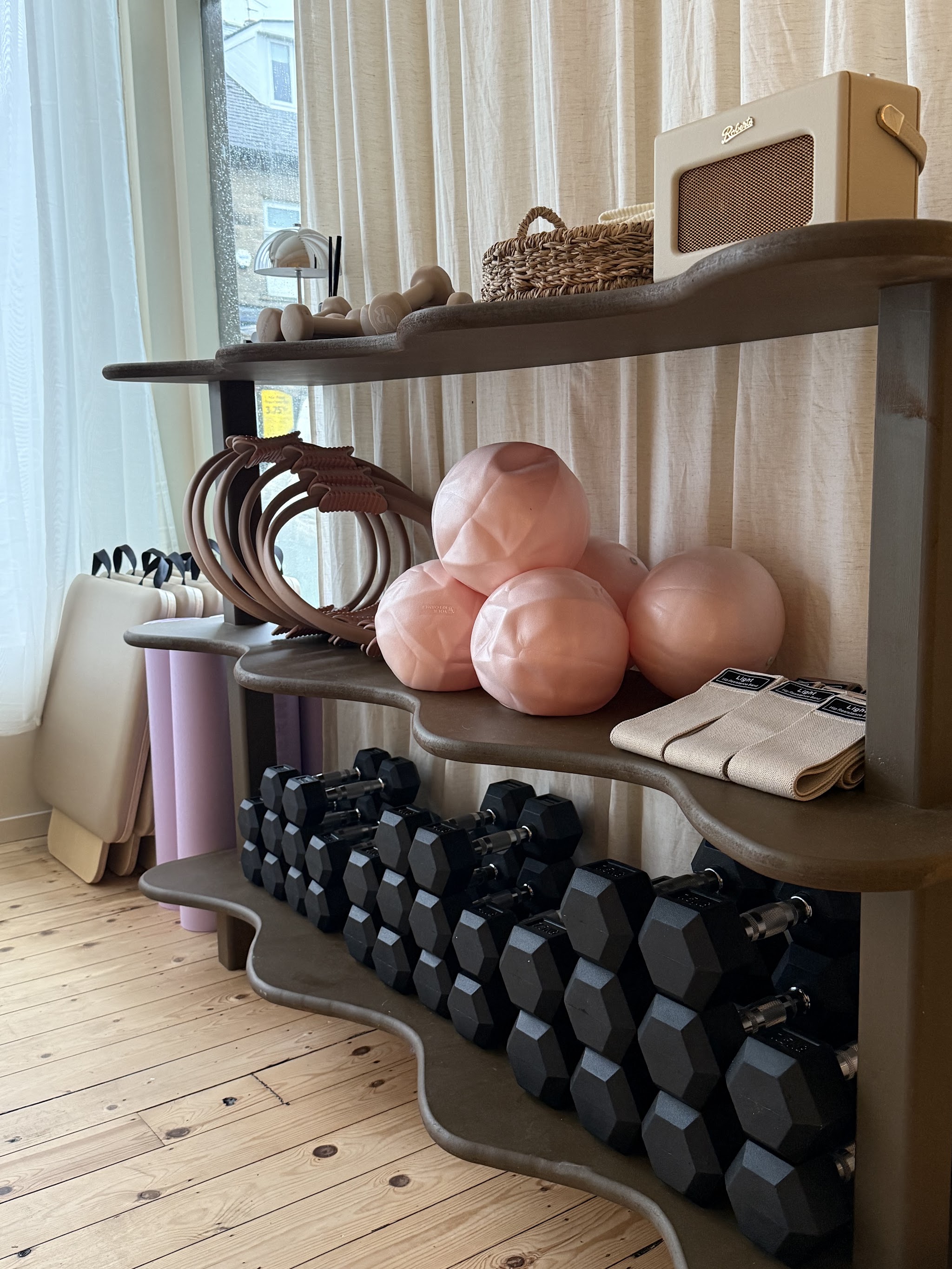 Pilates rings, soft balls and weights on our studio shelves
